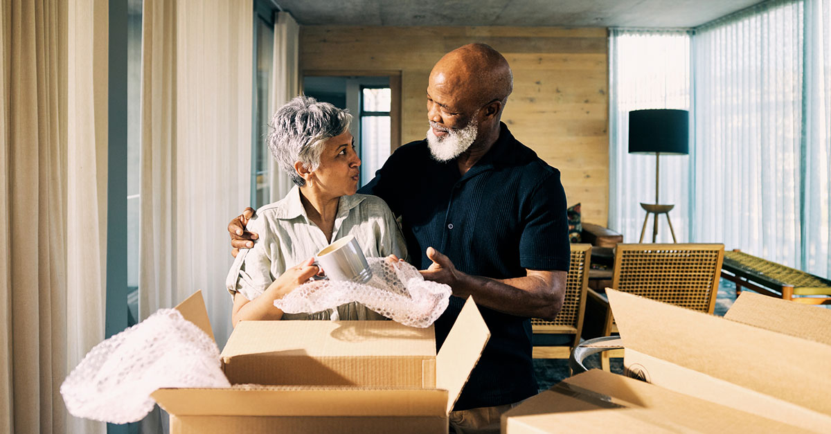 An older couple moving into a new apartment