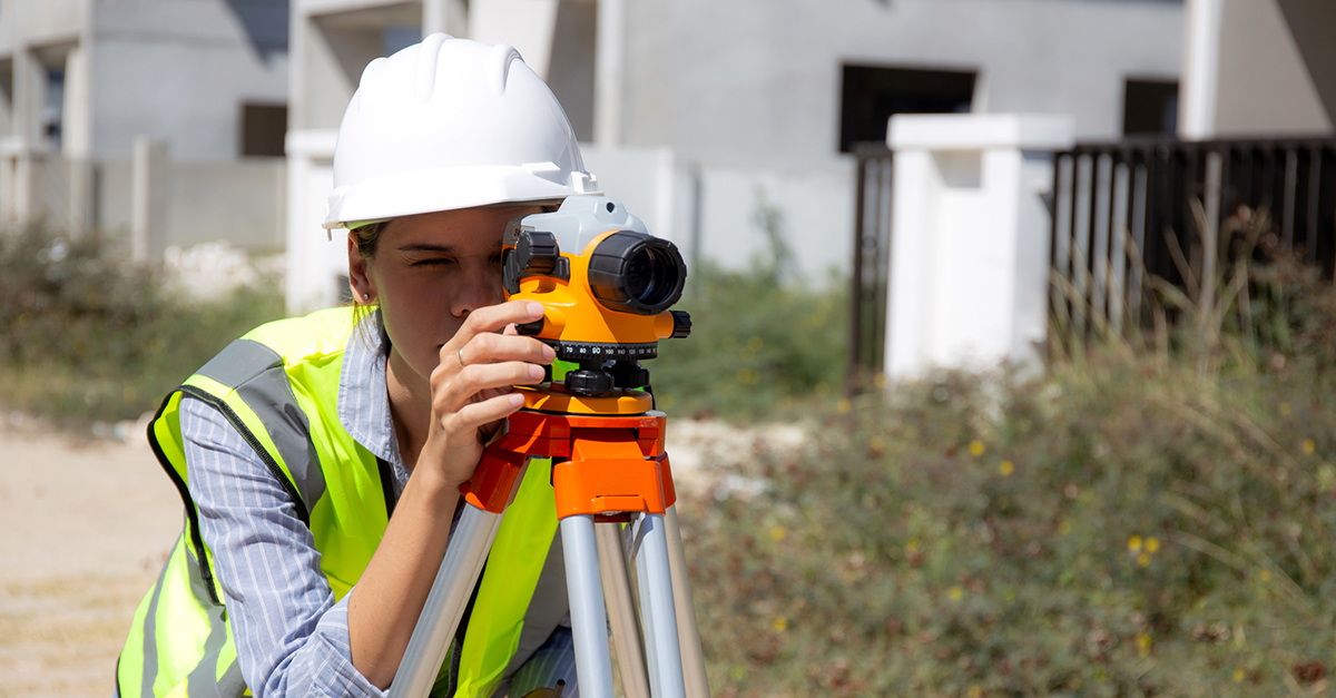 A surveyor surveys the land