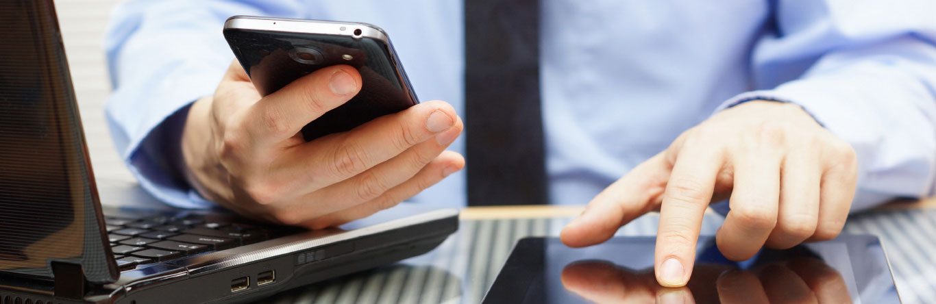 man using multiple smart devices